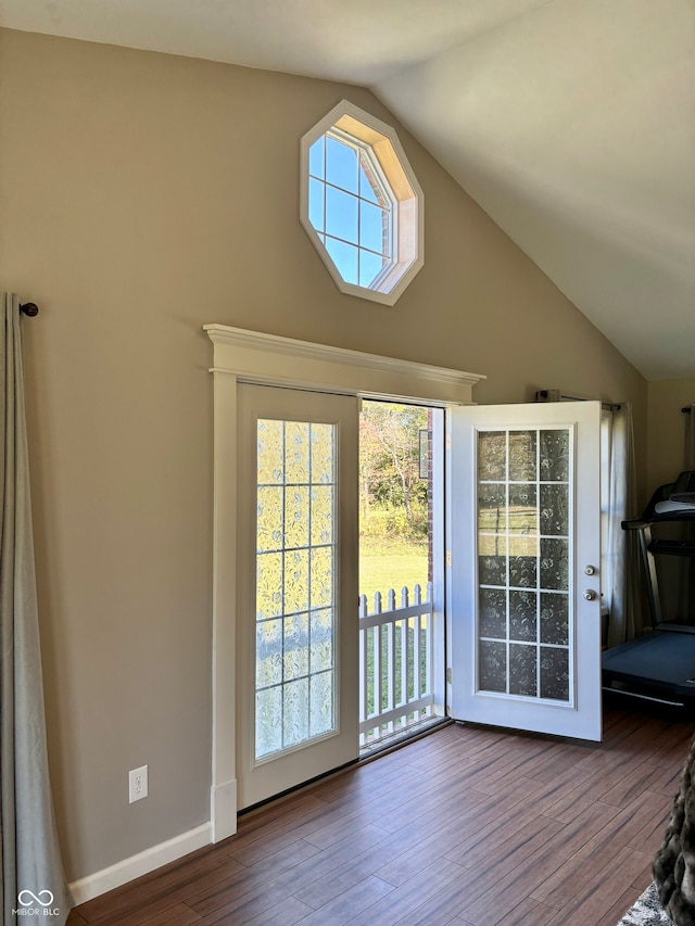 doorway featuring hardwood / wood-style flooring and vaulted ceiling