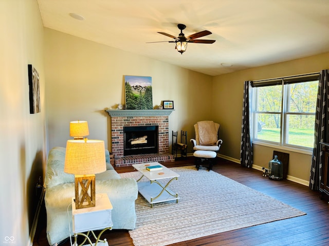 living room with ceiling fan, dark hardwood / wood-style flooring, and a fireplace