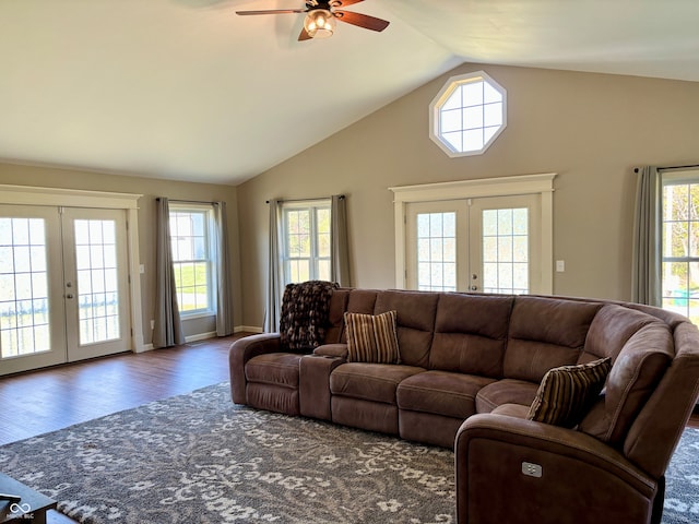 living room with a wealth of natural light, french doors, ceiling fan, and dark wood-type flooring