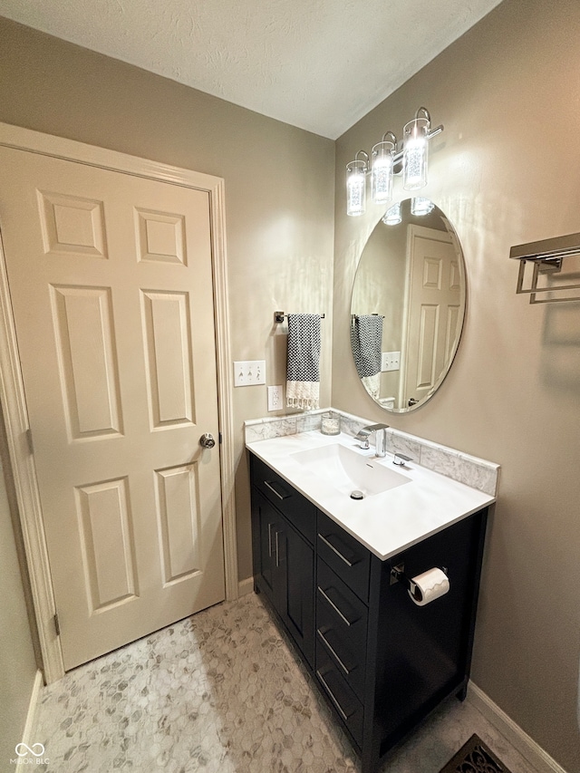 bathroom with vanity and a textured ceiling