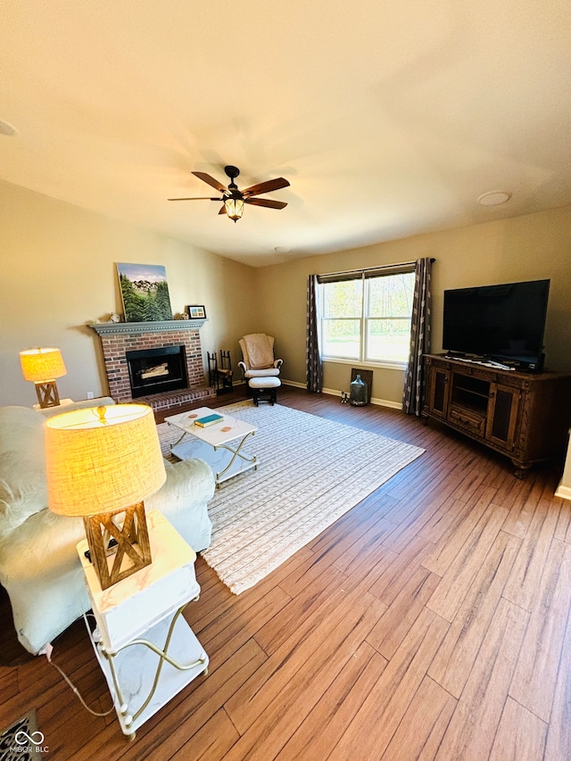 living room featuring a fireplace, ceiling fan, and hardwood / wood-style floors