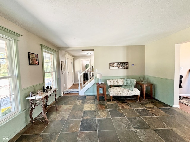 sitting room featuring a healthy amount of sunlight and a textured ceiling