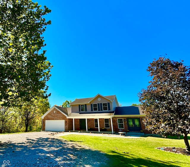 view of front of property with a front lawn and a garage