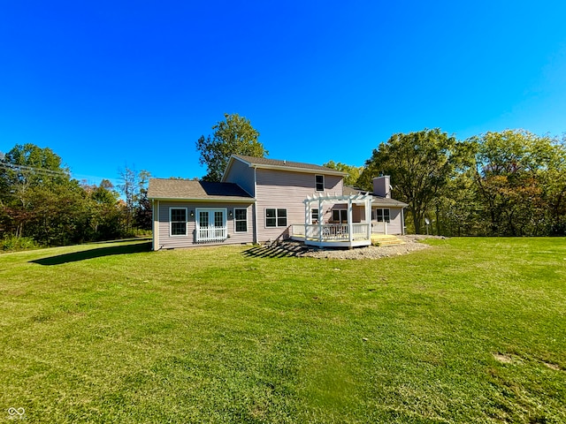 back of house featuring a yard, a pergola, and a deck