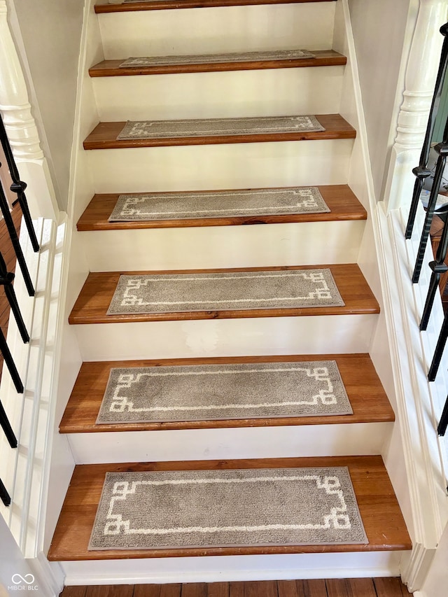 staircase featuring hardwood / wood-style flooring