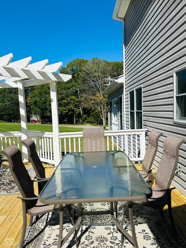 wooden terrace featuring a yard