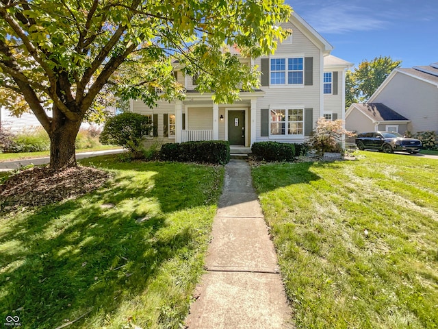 view of front of property with a front yard and covered porch