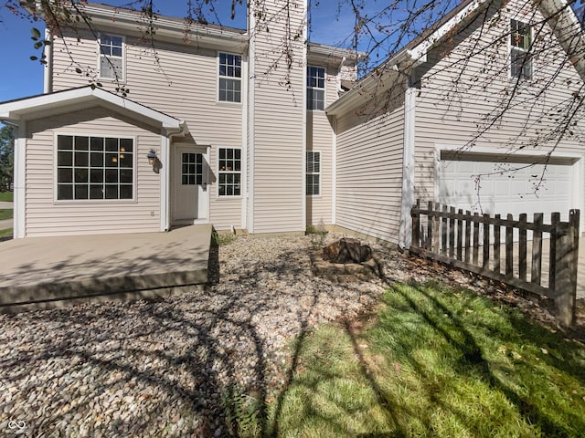 rear view of house featuring a garage