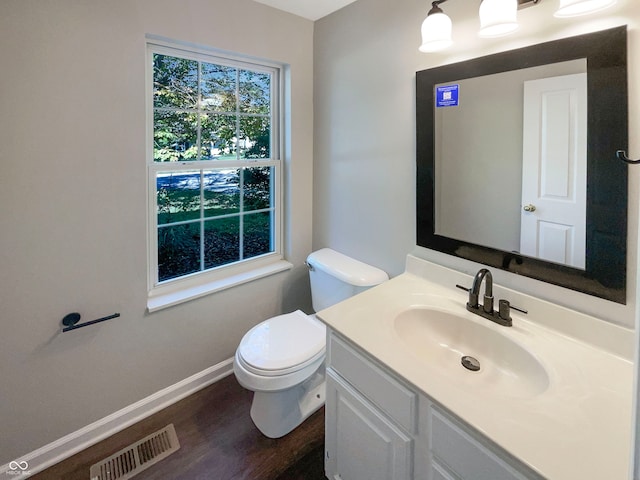 bathroom featuring hardwood / wood-style floors, vanity, and toilet