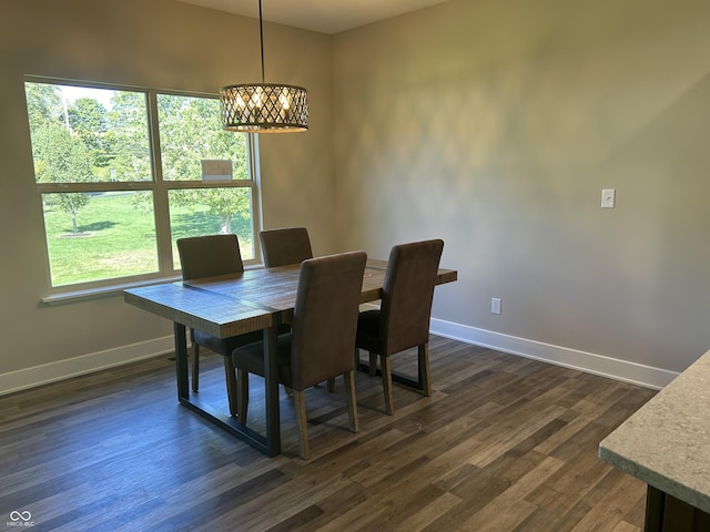 dining area with baseboards, a chandelier, and a healthy amount of sunlight