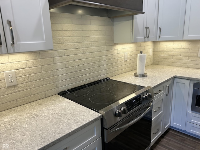 kitchen with dark wood-type flooring, electric stove, and backsplash