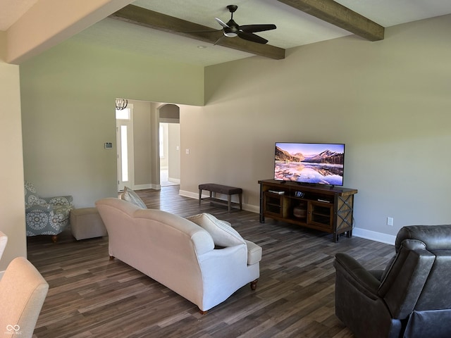 living area with baseboards, dark wood-type flooring, beamed ceiling, ceiling fan, and arched walkways