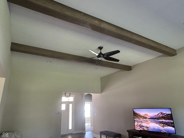 interior details featuring beamed ceiling, ceiling fan, and arched walkways