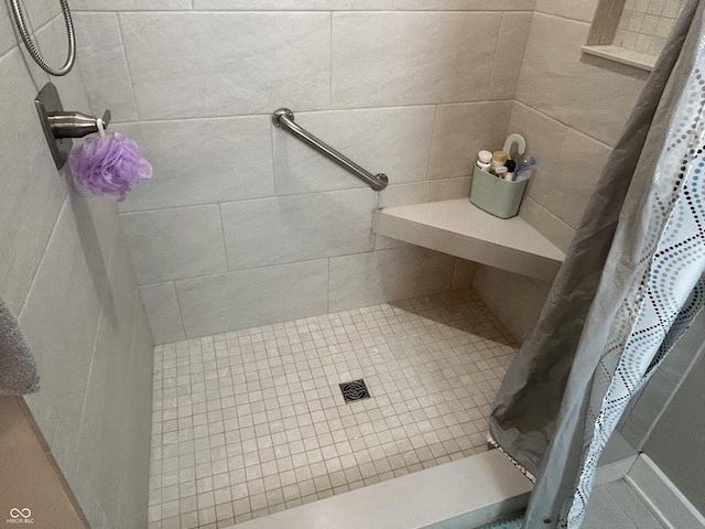 bathroom with a tile shower