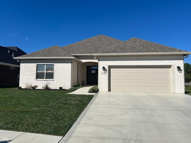 view of front of home with a front yard and a garage