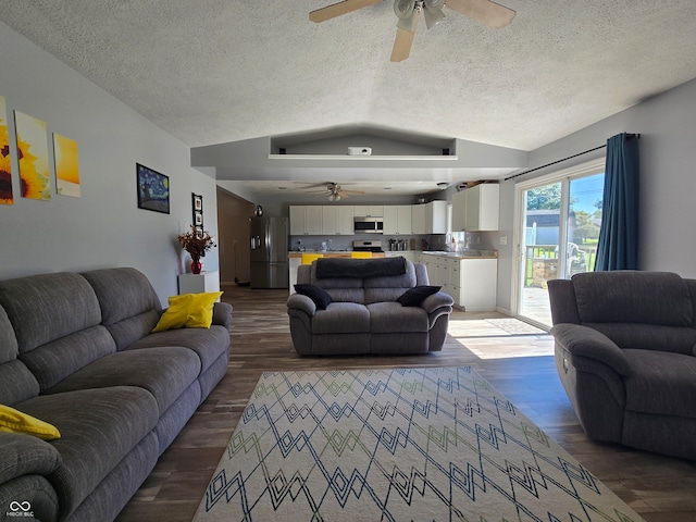 living room with lofted ceiling, a textured ceiling, ceiling fan, and dark hardwood / wood-style flooring