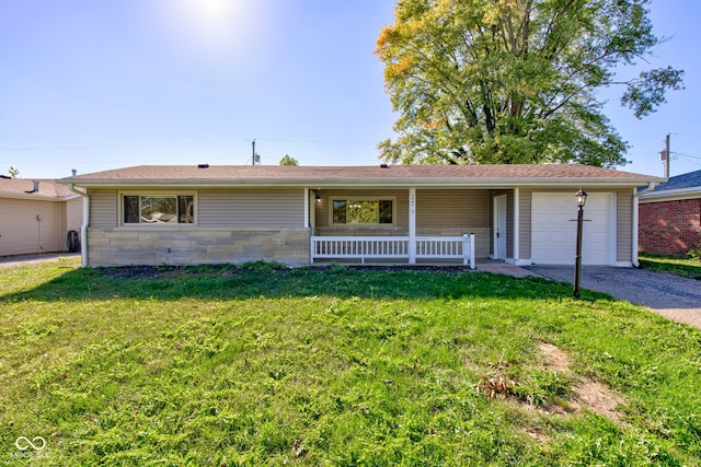 ranch-style home featuring a garage, a porch, and a front lawn