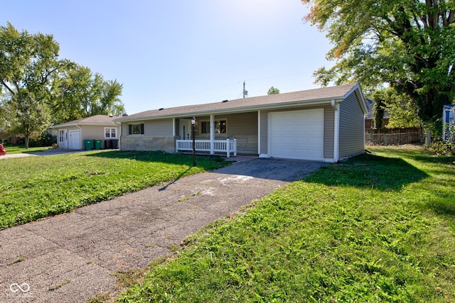 ranch-style house with a garage, covered porch, and a front yard