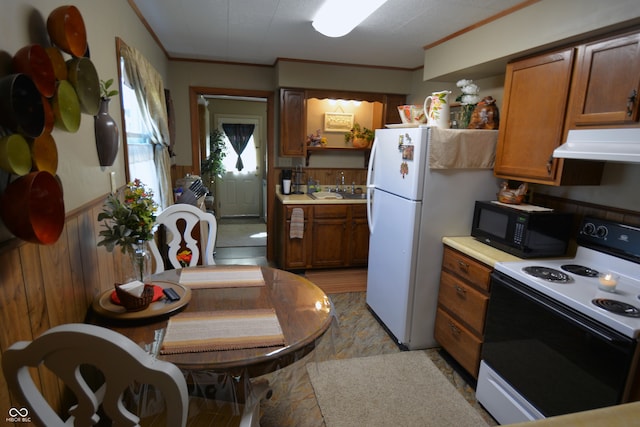 kitchen featuring white appliances and crown molding