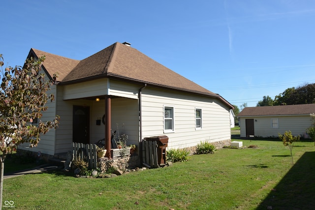 back of property featuring a yard