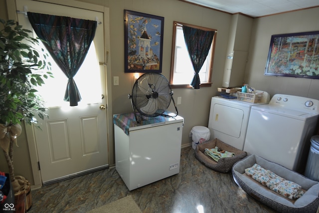 laundry area with ornamental molding and washer and clothes dryer