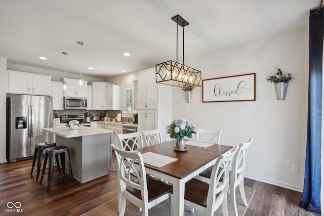 dining area with an inviting chandelier and dark wood-type flooring