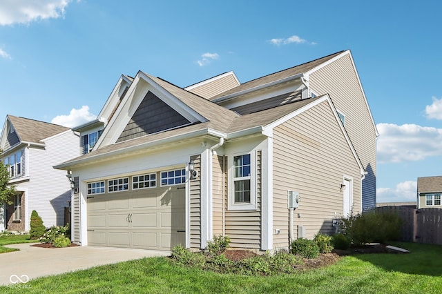 view of side of property with a lawn and a garage