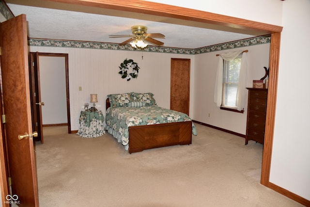 bedroom with baseboards, ceiling fan, and light colored carpet
