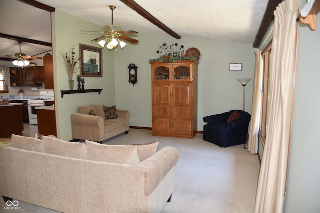 living room featuring vaulted ceiling with beams, ceiling fan, light colored carpet, and a textured ceiling