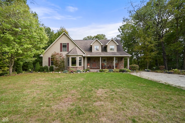 view of front of house featuring covered porch and a front yard