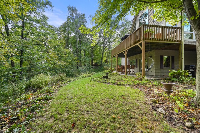 view of yard featuring a patio and a deck