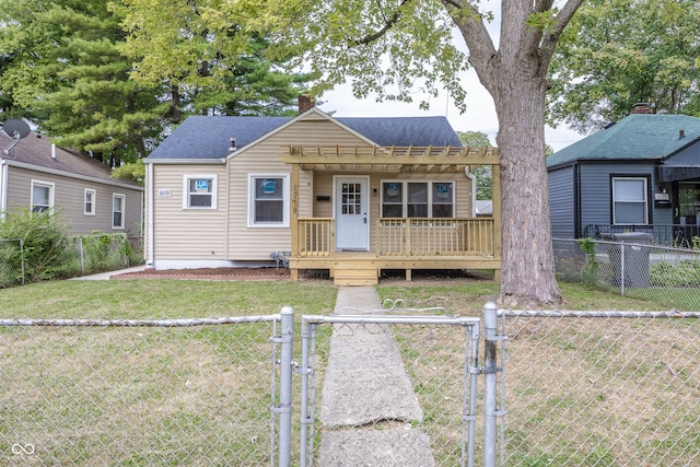 bungalow-style home featuring a wooden deck and a front lawn