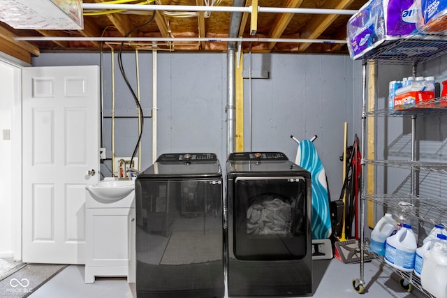 clothes washing area featuring washing machine and dryer and sink