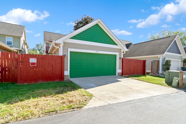 view of front of home with a front lawn and a garage