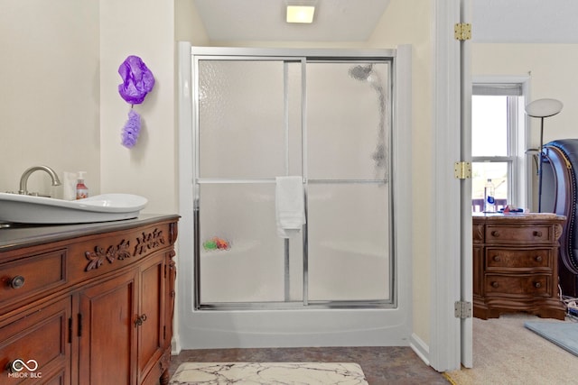 bathroom featuring vanity and a shower with door