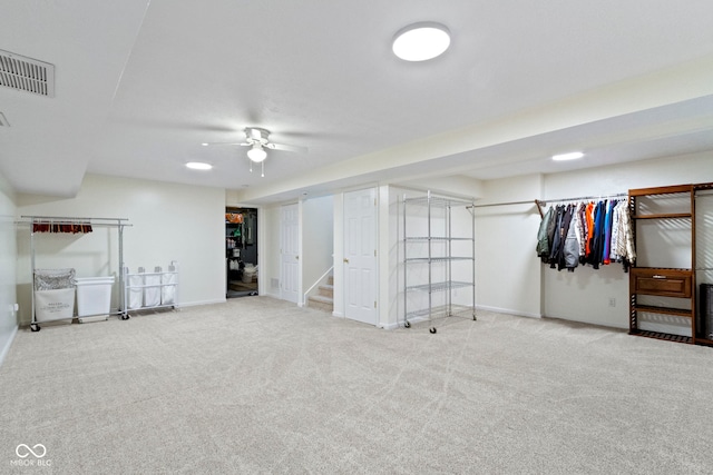 basement with ceiling fan and carpet floors