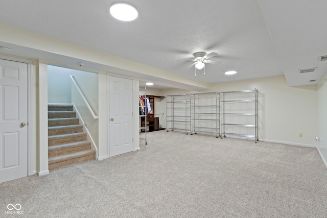 basement featuring ceiling fan and carpet