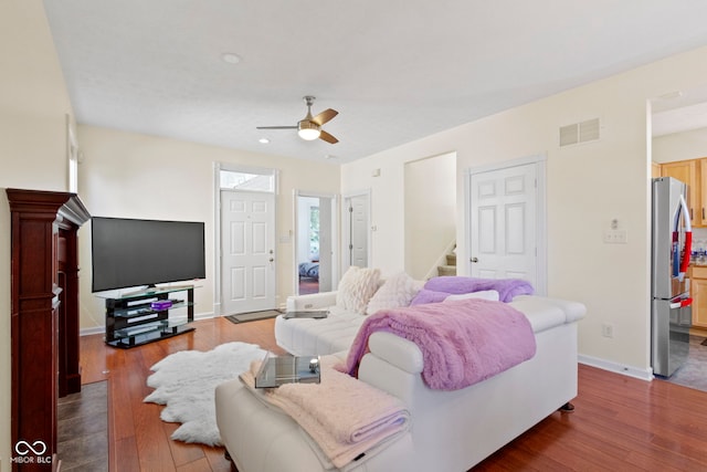 bedroom featuring ceiling fan, stainless steel fridge, and hardwood / wood-style floors