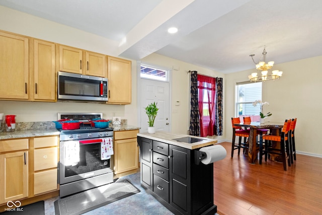 kitchen featuring light brown cabinetry, dark wood-type flooring, decorative light fixtures, a notable chandelier, and stainless steel appliances