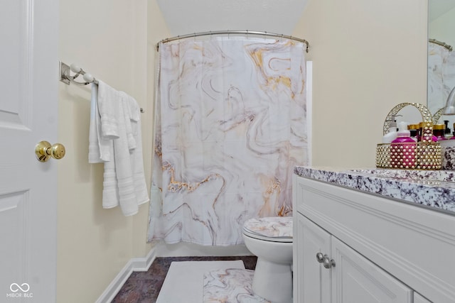 bathroom featuring vanity, tile patterned flooring, and toilet