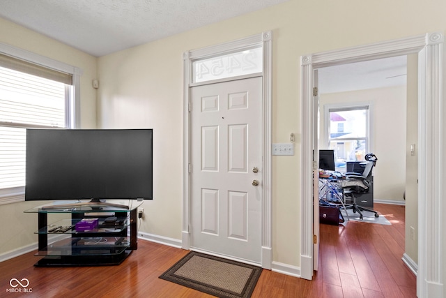 foyer entrance with a textured ceiling and hardwood / wood-style floors