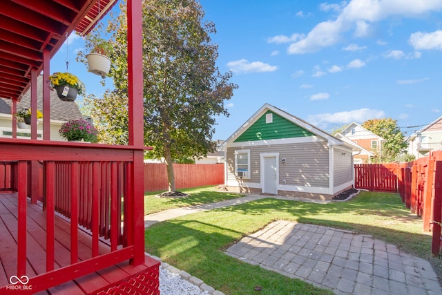 view of yard featuring a deck and an outdoor structure