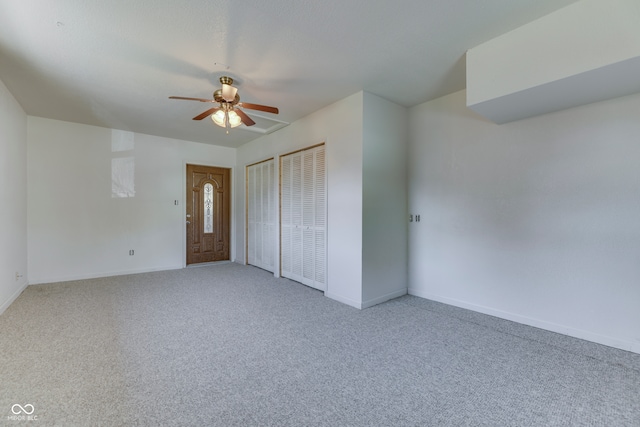 interior space featuring ceiling fan and carpet