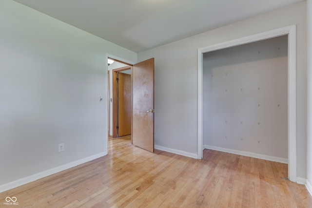 unfurnished bedroom with light wood-type flooring