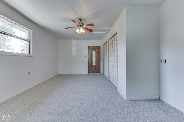 carpeted empty room with ceiling fan