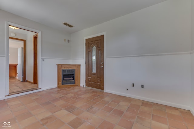 unfurnished living room featuring a fireplace and light tile patterned floors