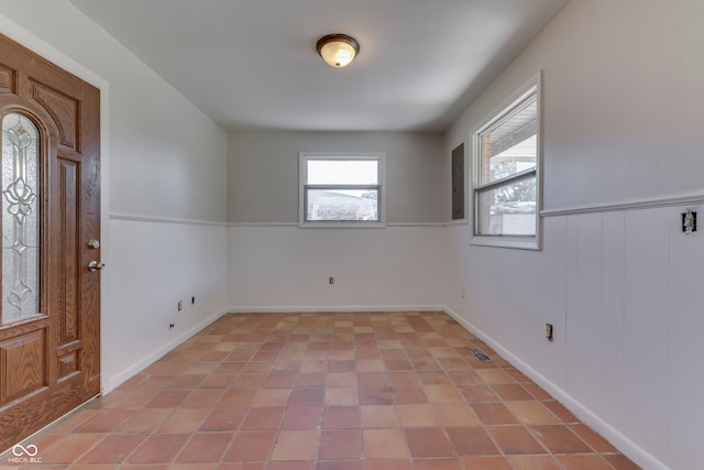 entryway featuring electric panel and light tile patterned flooring