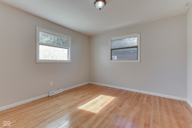 empty room with light hardwood / wood-style floors