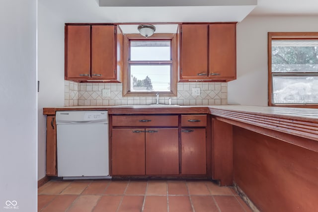 kitchen featuring dishwasher, backsplash, and a wealth of natural light