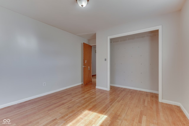 unfurnished bedroom with light hardwood / wood-style floors and a closet